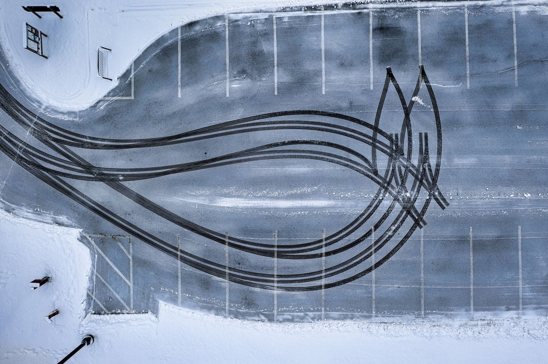 Aerial view of intricate tire tracks on a snowy parking lot in winter, Plainview, MN.