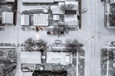 Aerial view of a snowy suburban area in Wabasha, Minnesota, showcasing quiet winter streets.